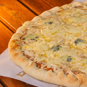 Mouthwatering cheese pizza served on a wooden table, perfect for food lovers.